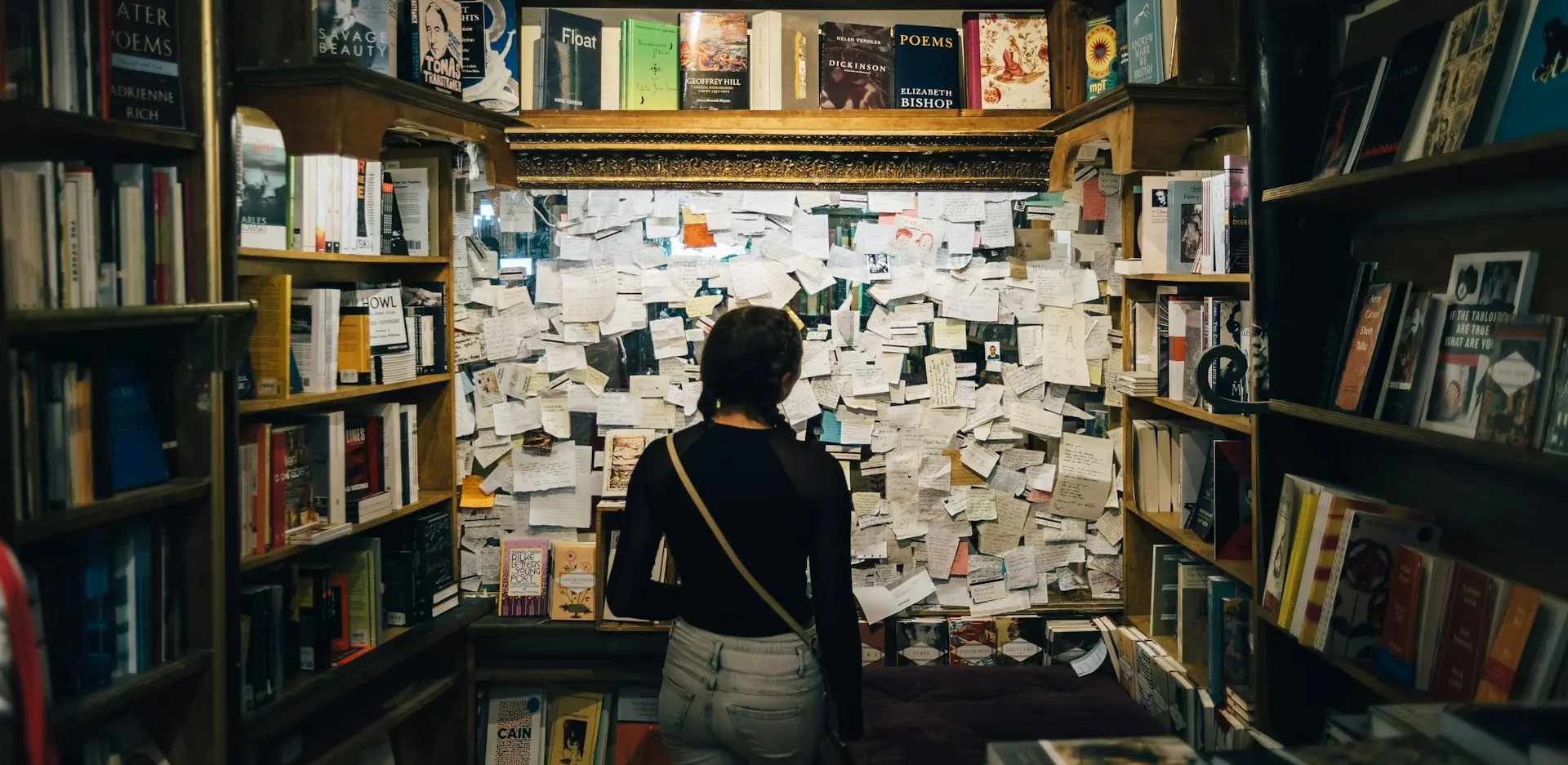 woman wearing white shirt standing inside library